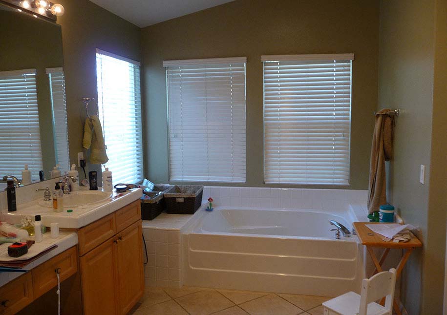 BEFORE: blinds on windows, small tub, dark cabinets - x-large photo