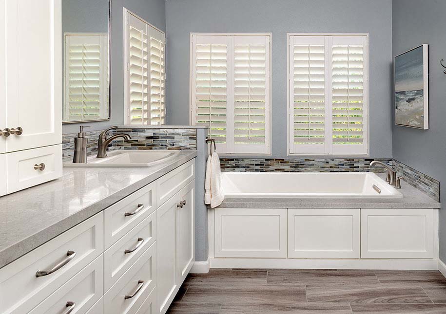 Shuttered windows, large tub, white cabinetry - x-large photo