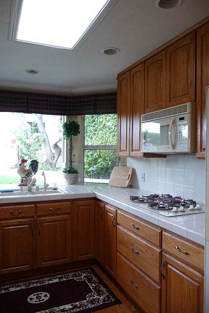 BEFORE: dated counter tile and dark cabinets in kitchen - x-large photo